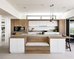 a kitchen with an island and stools in it