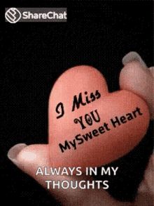 someone holding a pink heart with the words 9 miss you my sweet heart