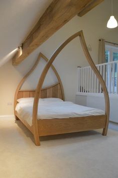 a bed that is in the middle of a room with white walls and flooring