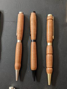 three different types of pens are lined up on the wall