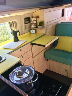 a kitchen with a stove top oven next to a counter and cupboards in the back