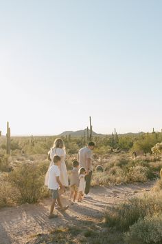 a group of people walking down a dirt road