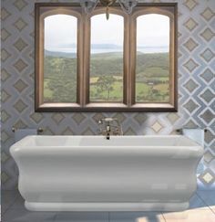 a white bath tub sitting under two windows