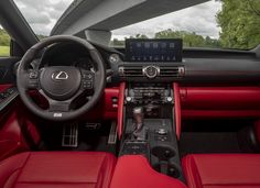 the interior of a car with red leather seats and steering wheel, dash board, touch screen