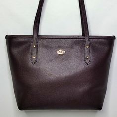 Like New! Beautiful Deep Purple/Brown In Color (Oxblood). Leather Exterior. Full Zip Closure. Gold Tone Hardware. Lined Interior With Two Slip Pockets. Brand: Coach Measurements: 13"L X 8"H X 4"W Posh Ambassador Top Rated Seller Fast Shipper Reasonable Offers Accepted Classic Purple Leather Shoulder Bag, Classic Purple Shoulder Bag, Classic Purple Bag For Everyday Use, Classic Purple Bags For Everyday Use, Classic Everyday Purple Bag, Classic Purple Shoulder Bag For Everyday, Classic Purple Everyday Bag, Classic Purple Bag With Branded Hardware, Classic Purple Bags With Branded Hardware