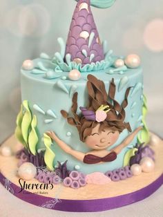 there is a cake decorated with an image of a mermaid on it