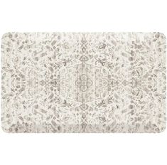 a white rug with an ornate design on the front and back side, in grey tones