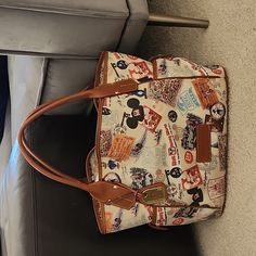 Disney Dooney & Bourke 40th Anniversary Kristen Handbag. Good/ Fair Condition Second Owner- I Have Never Used It- Making Room In My Closet! Disney Rectangular Shoulder Bag For Travel, Disney Style Rectangular Shoulder Bag For Travel, Disney Style Shoulder Bag For Travel, Disney Style Travel Shoulder Satchel Bag, Brown Disney Bags For Everyday Use, Disney Style Brown Bag For Everyday Use, Disney Everyday Brown Bags, Disney Rectangular Travel Bag, Disney Shoulder Bag With Removable Pouch For Travel