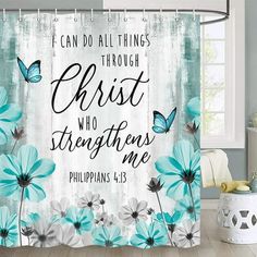 a shower curtain with blue and white flowers on it, which says i can do all things through christ who straightens me