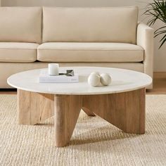 a living room with a couch, coffee table and two white balls on the floor