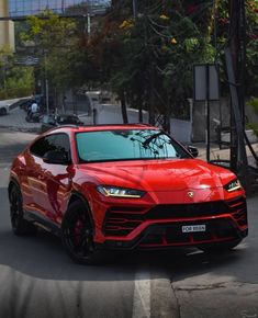 a red sports car is driving down the street