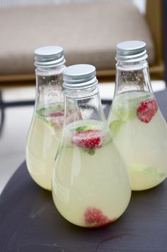 three bottles filled with liquid sitting on top of a table