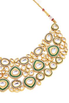 22k gold plated necklace with green meenakari work and kundan embellishment. Comes with earrings and maangtikka.
Components: 1 Necklace, Pair of earrings, 1 Maangtikka
Type: Kundan
Composition: Mixed Metal Alloy
Color: Green
Other Details: 
Dimensions L x B x H (in cm):
Necklace: 36.5 x 5.7 x 0.5
Earrings: 6 x 2.5 x 0.5
Maangtikka: 12 x 2.5 x 0.5
Weight (in gms): 170
Closure:
Necklace: Pull out drawcord
Earrings: Push back clasp
Maangtikka: Fish hook - Aza Fashions Green Gold Plated Kundan Necklace For Festivals, Green Gold-plated Kundan Necklace For Festivals, Green Kundan Necklace With Meenakari In Gold Plated, Gold-plated Green Kundan Necklace With Meenakari, Green Kundan Necklace With Meenakari Detail, Green Kundan Necklace With Tilla In 22k Gold, Green Kundan Necklace In 22k Gold For Celebrations, Festival Green Kundan Necklace In 22k Gold, Green 22k Gold Kundan Necklace With Tilla