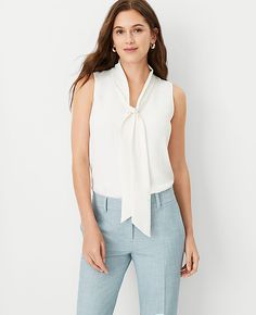 Elevate your wardrobe with the Ann Taylor Bow Neck Shell Top, a perfect blend of elegance and comfort. This winter white top is designed to flatter with its V-neck adorned with charming self-ties, creating a sophisticated bow neckline. Ideal for both office wear and social gatherings, it features a sleeveless design and a flowing shirttail hem that enhances its graceful silhouette.

- **Size:** Large
- **Color:** Winter White
- **Material:** 100% Polyester
- **Fit:** Straight Fit
- **Length:** 2 Lisa Fischer, White Bow Tie, Shell Top, Fall Capsule Wardrobe, Petite Tops, White Bow, Spring Wardrobe, Work Blouse, Tie Neck