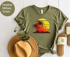 "Retro Tropical Sunset Summer Shirt, Summer Vibes Tshirt, Palm Beach Shirt, Beach Trip Gifts, Funny Summer Camp Tee, Cute Unisex Graphic Tee Please Check All Photos For Details.   🐞Choose Your T-Shirt Size From The Drop-Down Lists Next To The item Picture   ⭐Choose Of Your T-Shirt Color From The 2nd Picture   🐞Use \"Add message to Seller\" link On The Checkout Page To Send me the Following important Details For Your Order's Customization.   ⭐Shipping Time Varies by location (we are located in Sugar Land, Texas) please consider that our turn around time is 1 to 3 business days.     ⭐Which brand do you use for t-shirts? We use Gildan Softstyle, Bella Canvas Unisex, Hanes, Outlash, Tees,  District and Next Level when we have a shortage of stocks for certain colors and sizes. Our printing me Casual T-shirt For Outdoor Summer Activities, Casual Summer T-shirt For Outdoor, Summer Outdoor Cotton T-shirt, Summer Graphic Tee For Outdoor, Summer Graphic Print Tops For Outdoor, Graphic Tee Tops For Outdoor Summer Activities, Graphic Tee Tops For Summer Outdoor, Cotton Tops For Outdoor Beach Season, Green Camp Shirt For Beach And Summer