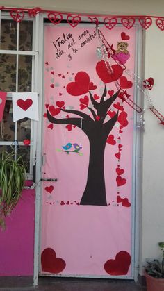 a door decorated with hearts and a tree