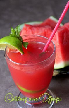 a watermelon drink with a lime garnish on the rim