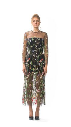 Sheer Embroidered Floral Long Column Dress with Long Sleeves and Attached Black Lining.  Dress has slightly flared hemline and Centre-back invisible zipper closure.  Dry Clean Only. All dresses are individually-made in Vancouver, Canada.  Dresses ship within 2 weeks of an order being placed. Fabric is 100% Polyester Embroidered Tulle.  Lining is 95% Polyester/5% Spandex. Dress is available in four sizes: XSMALL, SMALL, MEDIUM, and LARGE. Model is 5'10, 125lbs, and is wearing a size SMALL. X-SMAL Fitted Floor-length Embroidered Dress, Long Sleeve Fitted Dress With Floral Applique, Fitted Embellished Maxi Dress For Spring, Long Sleeve Evening Dress With Floral Embroidery, Evening Dresses With Long Sleeves And Floral Embroidery, Spring Long Sleeve Dress With Back Zipper, Long Sleeve Dress With Back Zipper For Spring, Long Sleeve Dress With Floral Embroidery For Cocktail, Spring Evening Embroidered Dresses