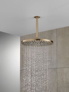 an overhead shower head with water running down it