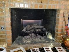 a fireplace is shown with pictures on the mantle and other items in front of it