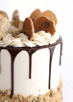 a cake with white frosting and cookies on top