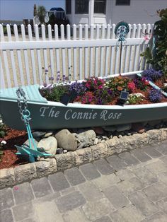 a boat is sitting in the flower bed