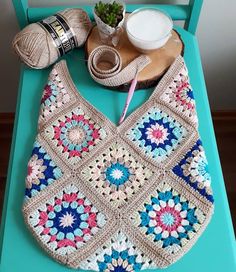 a crocheted purse sitting on top of a blue table