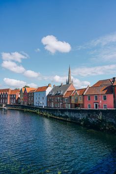 some buildings are next to the water on a sunny day