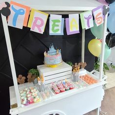 there is a birthday cake and cupcakes on the table