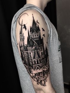 a man with a castle tattoo on his arm