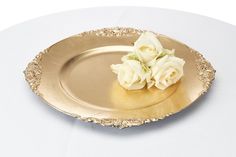 a gold plate with white flowers on it