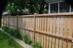 a wooden fence in front of a house