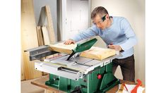 a man using a table saw to cut wood