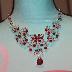 Nwt: Lace Looking Necklace With Red Rhinestone Flower In The Center, It Is Silver Tone, It Has A Large Teardrop Red Rhinestone Hanging From The Center Of The Necklace, It Is 3" Tall From The Top To The Bottom, 18" Long Chain Elegant Red Rhinestone Necklaces, Red Rhinestone Necklace For Gift, Red Teardrop Necklace For Party, Red Rhinestone Party Necklaces, Elegant Red Rhinestone Necklace For Formal Occasions, Elegant Red Rhinestone Necklace For Formal Events, Red Jeweled Rhinestone Necklace For Party, Elegant Red Rhinestone Necklace, Red Teardrop Necklace For Wedding