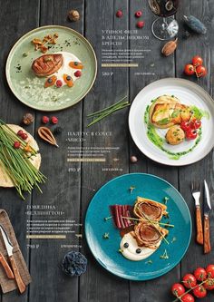 plates with food on them sitting on top of a wooden table next to utensils