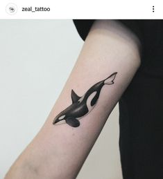 an orca whale tattoo on the arm