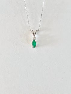 Genuine natural SMALL marquise shaped emerald measures 6 x 3.5mm (1/3 carat). Genuine tiny 2mm accent diamond. Both stones were handset in sterling silver. Sterling silver box chain is 18 inches long and can be switched to a 16 inch chain upon request. Necklace is perfect for a child or the minimalist. Comes in a gift box Emerald Cut Green Diamond Gemstone Necklace, Green Emerald Diamond Necklace For May Birthstone, Classic Green Diamond Pendant Necklace, Green Pendant Diamond Necklace In Classic Style, Classic Green Pendant Diamond Necklace, Anniversary Green Diamond Necklace For May Birthstone, Emerald Cut Green Diamond Necklace Gift, Fine Jewelry Emerald Teardrop Pendant Necklace For May Birthstone, Fine Jewelry Teardrop Emerald Necklace For May Birthstone