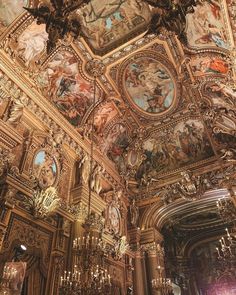 an ornate ceiling with paintings and chandeliers