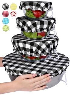 a stack of black and white checkered plates with tomatoes, lettuce and tomato slices in them