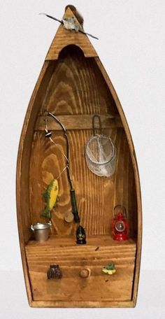 a small wooden boat with fishing accessories on the front and bottom shelf, as well as other items