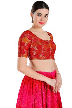 Product Features: Color: Red Fabric: Jacquard Pattern: Self Design Sleeves: Elbow Sleeves Neckline: Round Neck Clouser Type: Front Open Wash Care: First wash dry clean only Occasion: Partywear, Weddingwear Product Type: Blouse Disclaimer: There will be slight difference in digital to actual image Fitted Brocade Top With Unique Design, Fitted Brocade Top With Self Design, Padded Blouse Tops For Celebration, Fitted Red Brocade Choli, Fitted Red Blouse For Celebration, Fitted Red Choli For Party, Red Fitted Choli For Formal Occasions, Fitted Red Blouse, Fitted Formal Tops With Self Design