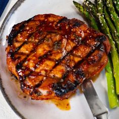 grilled meat and asparagus on a plate