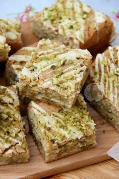 several pieces of cake sitting on top of a wooden cutting board