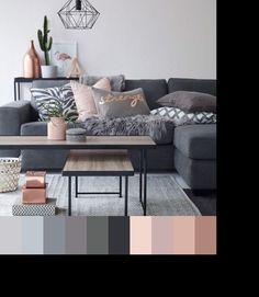 a living room with grey couches and pink accents on the walls, along with other furniture