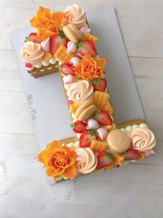 the letter e is made out of icing and decorated with flowers on top of it