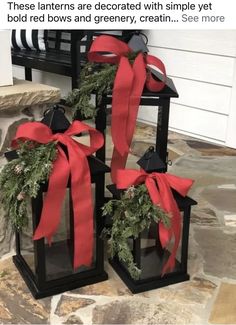 two black lanterns decorated with red bows and greenery