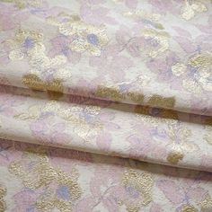 two pink and gold fabric with flowers on them