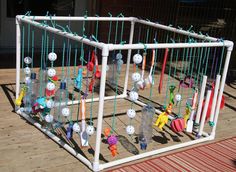 an outdoor play area made out of plastic bottle caps and stringed together with beads