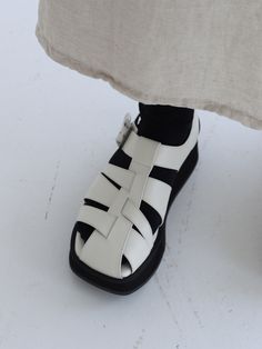 Editor's NotesThese sandals feature simple design and light weight. It is good to wear for various activities. - Silver buckle point- Unique strap- Summer shoes- Daily item- Goes well with any casual looksMeasurements(in.)- Size: KR 225MM(US 5.5) ~ KR 255MM(US 8.5)- Heel Height: 1.57 in.*Fits true to size.Composition & Care- Upper: Cowhide- Sole: Rubber- Please check the care labelDesigner- by MOL:pin Modern White Sandals With Single Toe Strap, Modern White Sport Sandals With Round Toe, Modern White Sport Sandals, Modern White Sandals With Rubber Sole, White Leather Closed Toe Sport Sandals, White Closed-toe Leather Sport Sandals, White Leather Closed-toe Sport Sandals, Modern White Closed Toe Sandals, White T-strap Sandals With Removable Insole