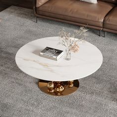 a white marble coffee table with gold accents in a living room setting on carpeted flooring